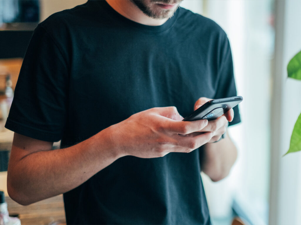 man texting on smartphone