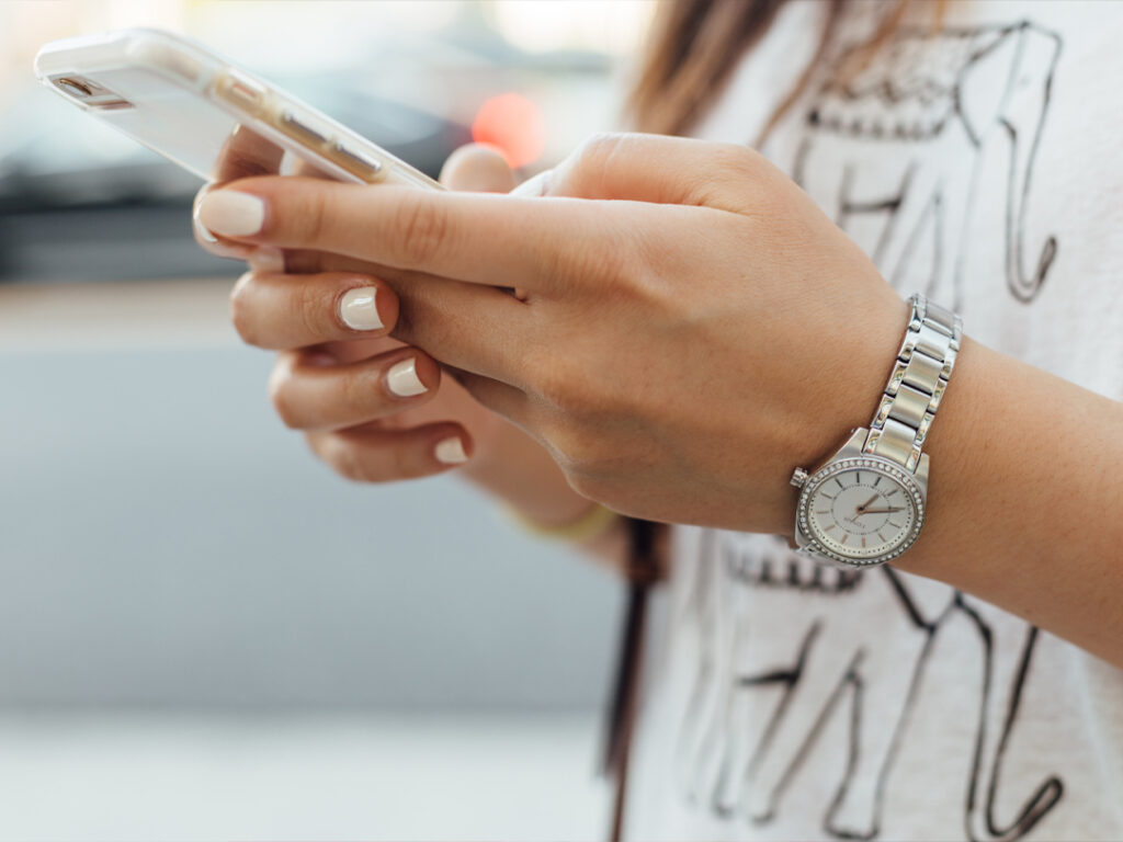 woman texting on smartphone